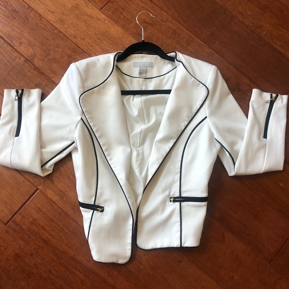 White blazer with a black outline & gold zippers